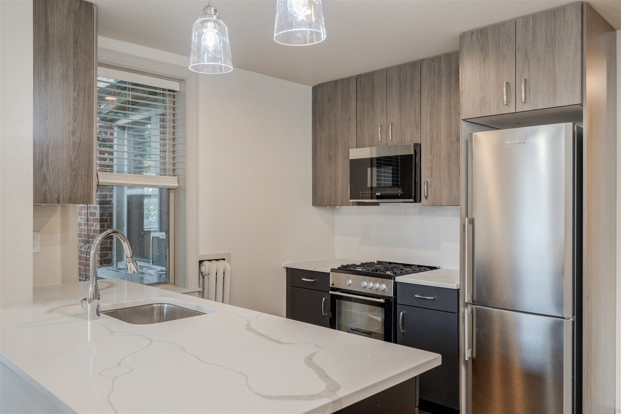 a kitchen with stainless steel appliances and a white counter top